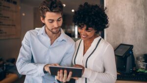 Business man and woman looking at an ipad.