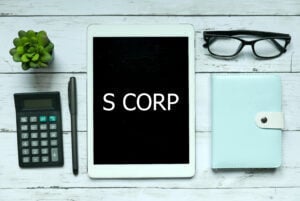 Business,concept.,top,view,of,plant,calculator,glasses,pen,notebook,and,tablet,written,with
